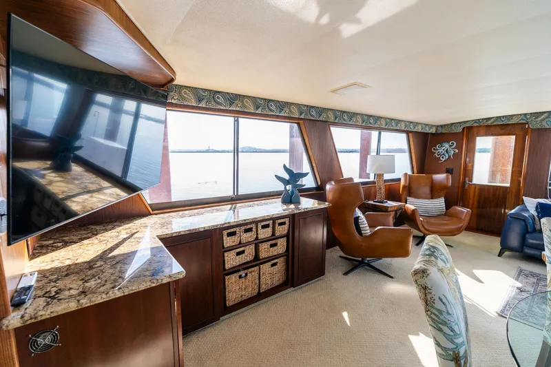 Slide: The Image of Luxurious interior of a 1986 Hatteras 63 Motor Yacht with elegant seating and large windows. - 29