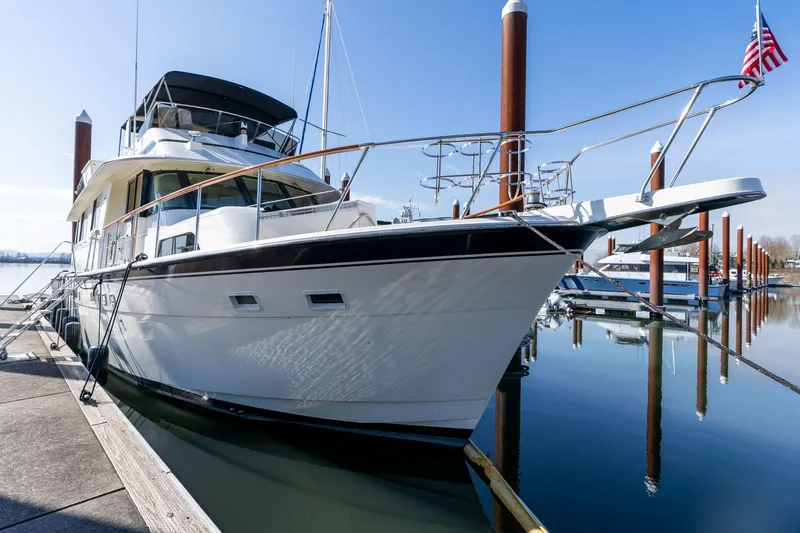 Slide: The Image of 1986 Hatteras 63 Motor Yacht docked at marina, clear sky, calm water. - 3