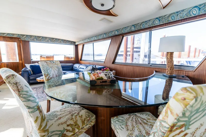 Slide: The Image of Luxurious interior of 1986 Hatteras 63 Motor Yacht with elegant dining area and panoramic windows. - 30