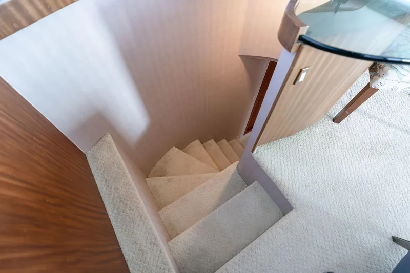 Slide: The Image of Interior staircase of 1986 Hatteras 63 Motor Yacht with carpeted steps and wooden accents. - 32