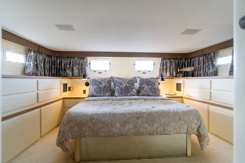 Slide: The Image of Luxurious bedroom interior of 1986 Hatteras 63 Motor Yacht with elegant bedding and decor. - 34