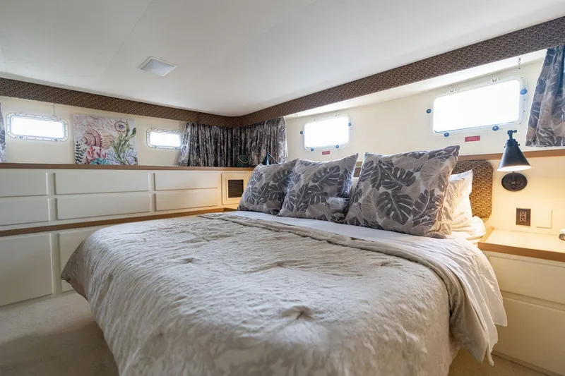 Slide: The Image of Luxurious bedroom interior of 1986 Hatteras 63 Motor Yacht with elegant bedding and decor. - 36