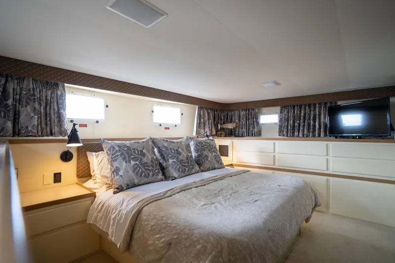 Slide: The Image of Luxurious bedroom interior of 1986 Hatteras 63 Motor Yacht with elegant bedding and natural light. - 38