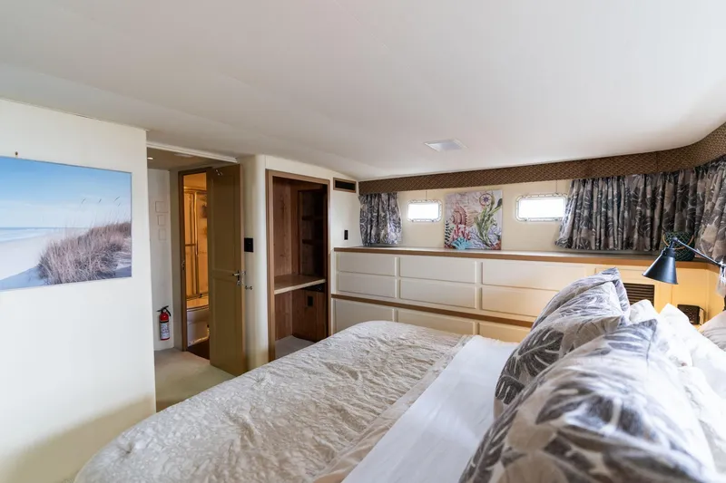 Slide: The Image of Luxurious bedroom interior of 1986 Hatteras 63 Motor Yacht with elegant decor and natural light. - 39