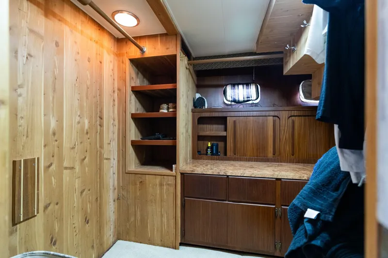 Slide: The Image of 1986 Hatteras 63 Motor Yacht interior with wooden cabinetry and shelving. - 41