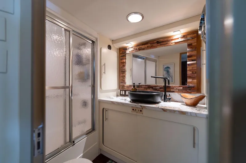 Slide: The Image of Luxurious bathroom in 1986 Hatteras 63 Motor Yacht with modern fixtures and elegant design. - 43