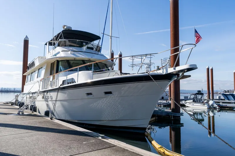Slide: The Image of 1986 Hatteras 63 Motor Yacht docked at marina, clear sky, calm water. - 5