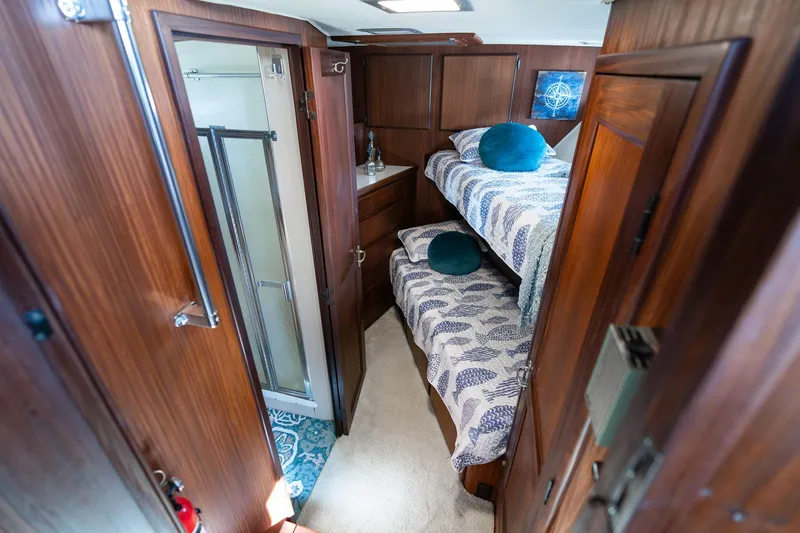 Slide: The Image of 1986 Hatteras 63 Motor Yacht cabin with bunk beds and wooden interior. - 51