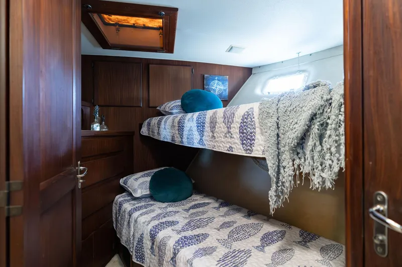 Slide: The Image of Cozy cabin with bunk beds in 1986 Hatteras 63 Motor Yacht, featuring nautical decor. - 52