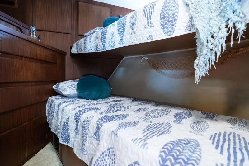 Slide: The Image of Interior of 1986 Hatteras 63 Motor Yacht with cozy bunk beds and nautical decor. - 53