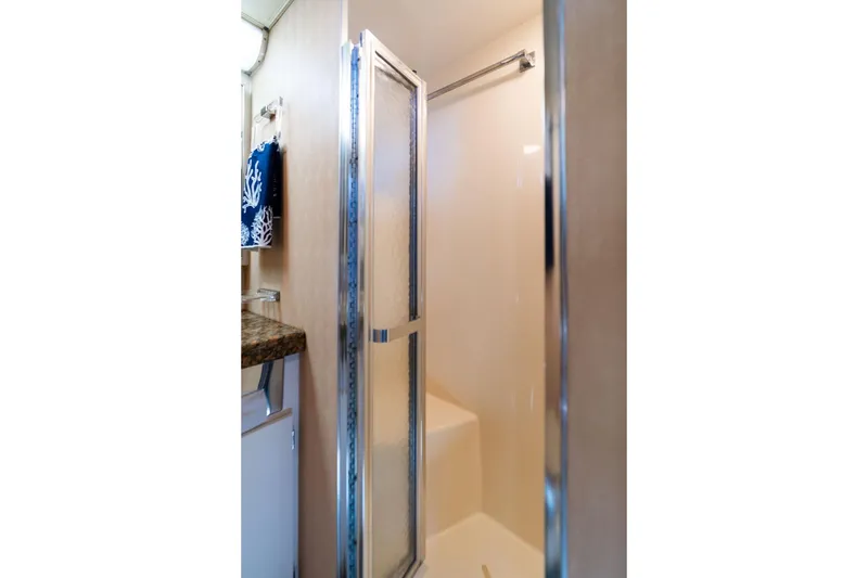 Slide: The Image of Shower area in 1986 Hatteras 63 Motor Yacht with glass door and towel rack. - 57