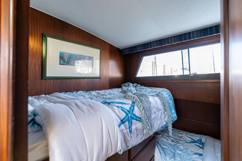 Slide: The Image of Cozy cabin interior of 1986 Hatteras 63 Motor Yacht with nautical-themed bedding. - 60