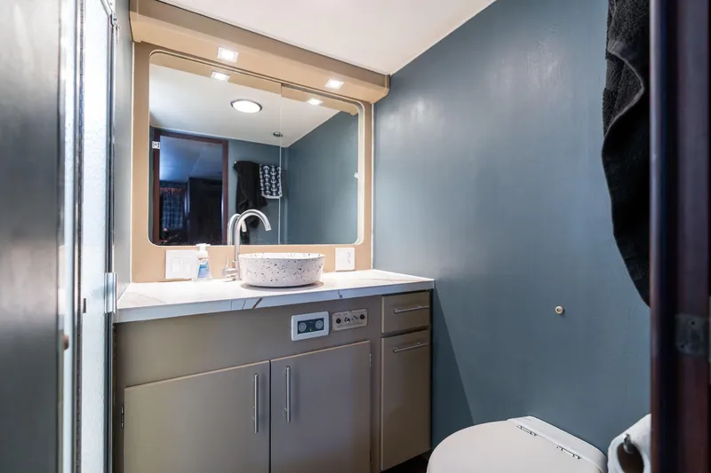 Slide: The Image of Bathroom interior of 1986 Hatteras 63 Motor Yacht with modern sink and mirror. - 67