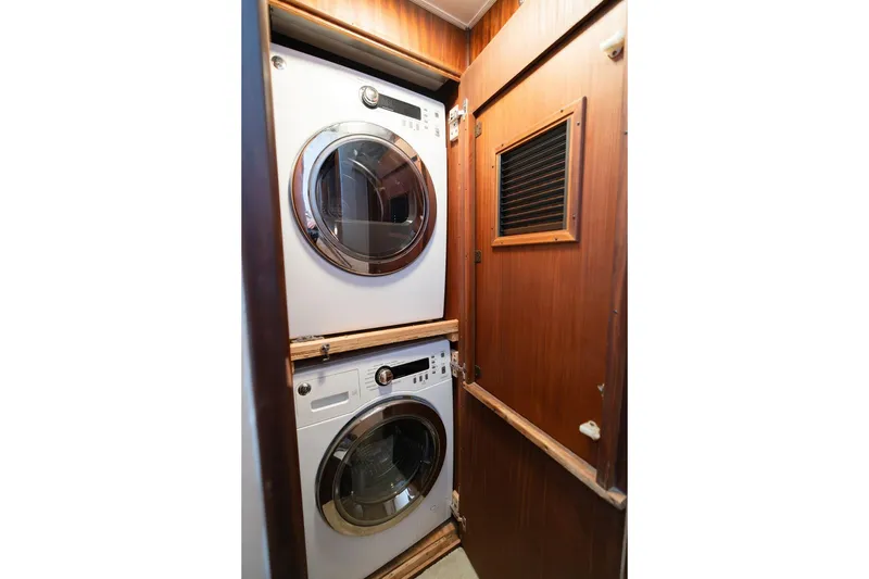 Slide: The Image of Stacked washer and dryer in 1986 Hatteras 63 Motor Yacht laundry area. - 71