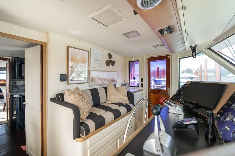 Slide: The Image of Interior of 1986 Hatteras 63 Motor Yacht with helm, seating, and nautical decor. - 72