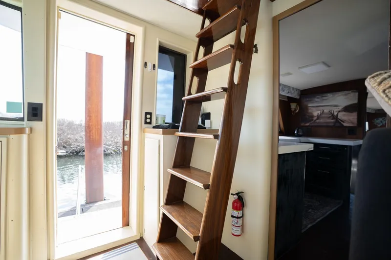 Slide: The Image of Interior of 1986 Hatteras 63 Motor Yacht with wooden stairs and modern decor. - 73