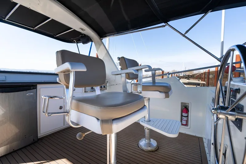 Slide: The Image of Captain's chairs on the deck of a 1986 Hatteras 63 Motor Yacht. - 78