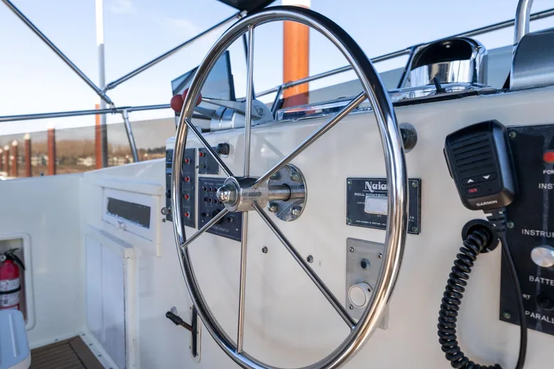 Slide: The Image of Helm of 1986 Hatteras 63 Motor Yacht with steering wheel and control panel. - 79