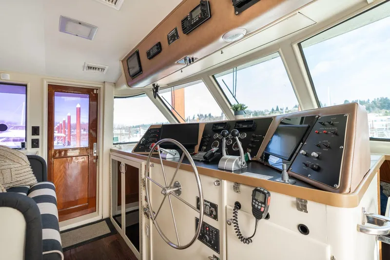 Slide: The Image of Interior helm of 1986 Hatteras 63 Motor Yacht with steering wheel and control panels. - 8