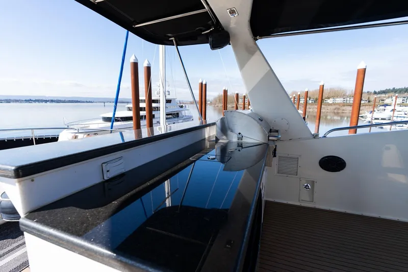 Slide: The Image of 1986 Hatteras 63 Motor Yacht deck with sleek design and waterfront view. - 83
