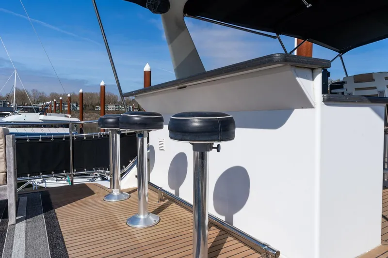 Slide: The Image of Bar stools on the deck of a 1986 Hatteras 63 Motor Yacht. - 87