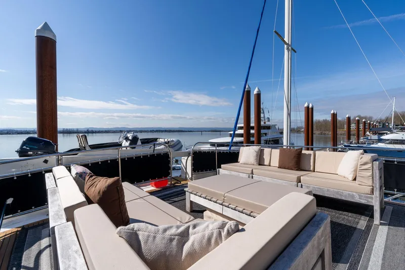 Slide: The Image of Luxurious deck seating on 1986 Hatteras 63 Motor Yacht, overlooking serene marina. - 88