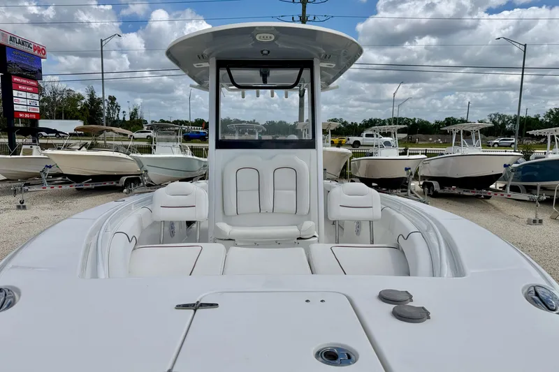 Slide: The Image of 2018 Sea Hunt Gamefish 27 boat with spacious seating, displayed outdoors under cloudy skies. - 11