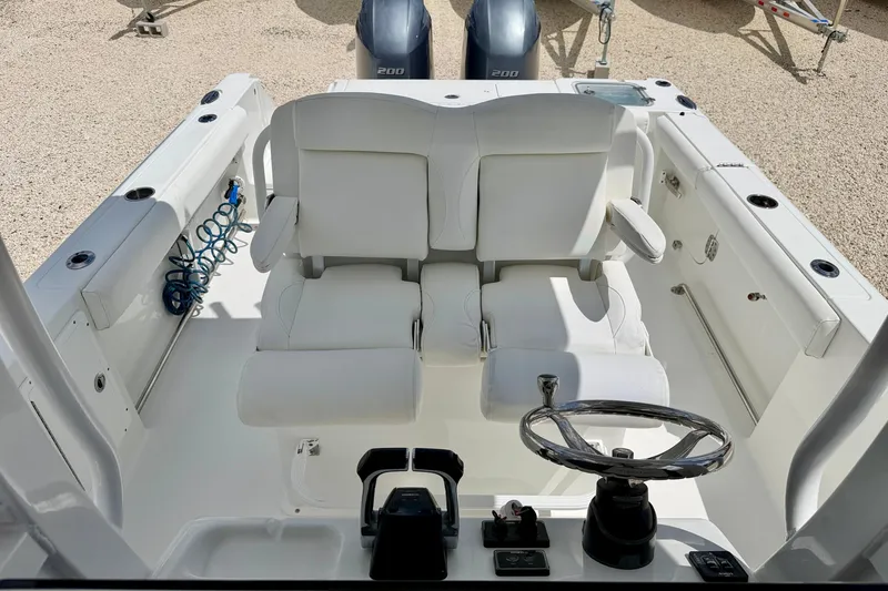 Slide: The Image of 2018 Sea Hunt Gamefish 27 boat interior with dual seats and steering wheel. - 14