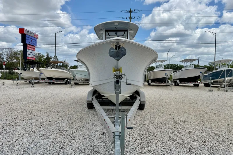 Slide: The Image of 2018 Sea Hunt Gamefish 27 boat on trailer at dealership, surrounded by other boats. - 2