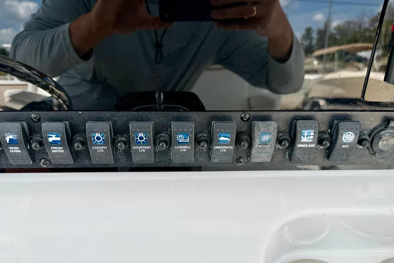Slide: The Image of Control panel of a 2018 Sea Hunt Gamefish 27 boat with various switches. - 27