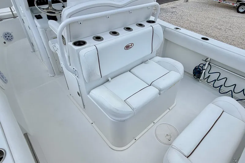 Slide: The Image of 2018 Sea Hunt Gamefish 27 boat interior with white seating and cup holders. - 29