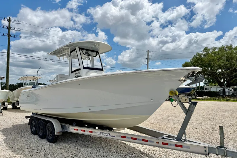 Slide: The Image of 2018 Sea Hunt Gamefish 27 boat on trailer under blue sky. - 3