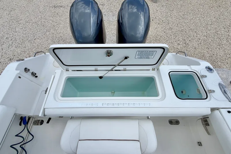 Slide: The Image of 2018 Sea Hunt Gamefish 27 boat with open storage compartments and dual engines. - 34