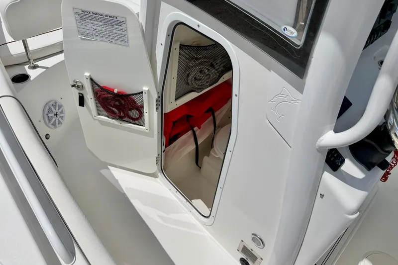 Slide: The Image of 2018 Sea Hunt Gamefish 27 boat storage compartment with open door and visible equipment. - 36
