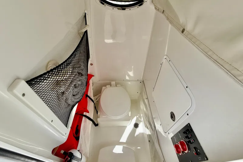 Slide: The Image of Interior of 2018 Sea Hunt Gamefish 27 boat with toilet and storage compartments. - 37
