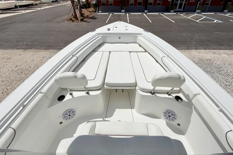 Slide: The Image of 2018 Sea Hunt Gamefish 27 boat interior with white seating and speakers. - 8