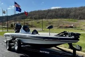 Slide: The Image of 2011 Nitro Z-6 boat on trailer with scenic mountain backdrop. - 6
