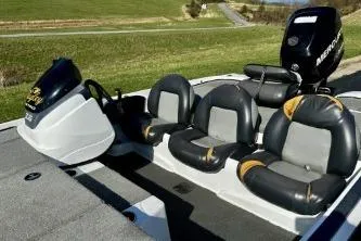 Slide: The Image of 2011 Nitro Z-6 boat interior with seating and Mercury engine, set against a grassy landscape. - 7