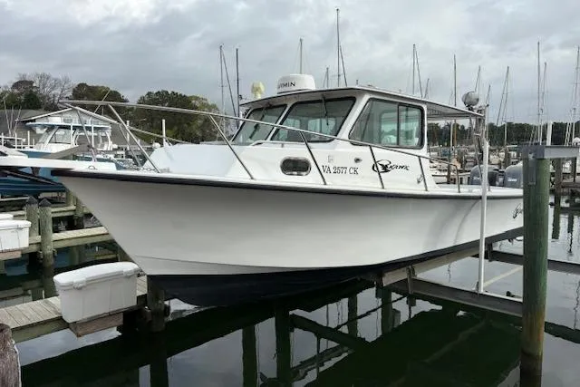 The Image of 1989 C-Hawk 29 Sport Cabin boat docked at marina, overcast sky. - 0