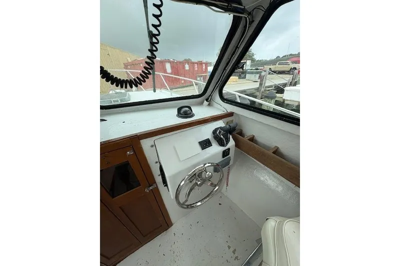 Slide: The Image of Interior of 1989 C-Hawk 29 Sport Cabin boat showing steering wheel and controls. - 14