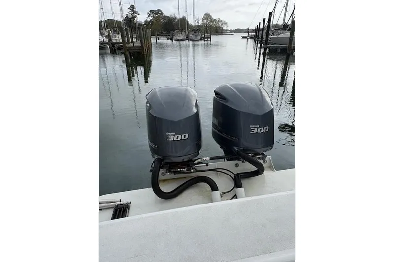 Slide: The Image of Twin Yamaha 300 outboard motors on a 1989 C-Hawk 29 Sport Cabin boat at a marina. - 17