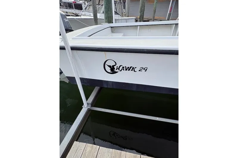 Slide: The Image of 1989 C-Hawk 29 Sport Cabin boat docked, featuring sleek white hull design. - 5