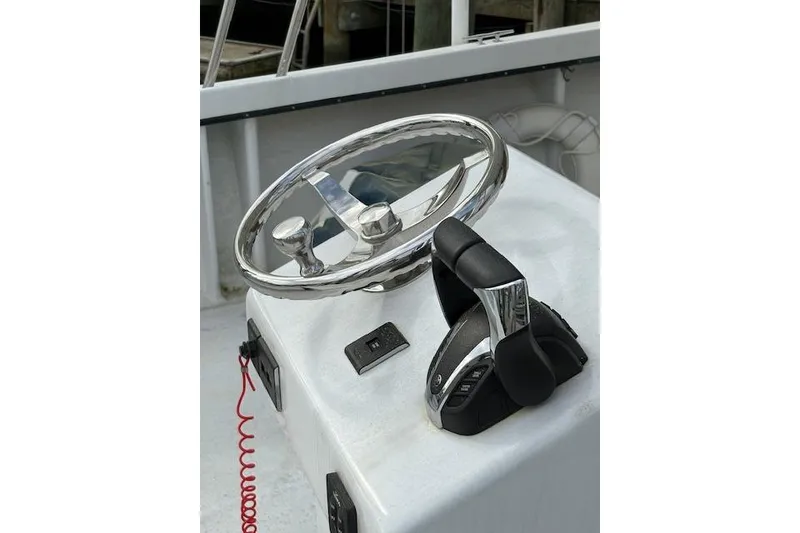 Slide: The Image of Steering wheel and controls of a 1989 C-Hawk 29 Sport Cabin boat. - 6
