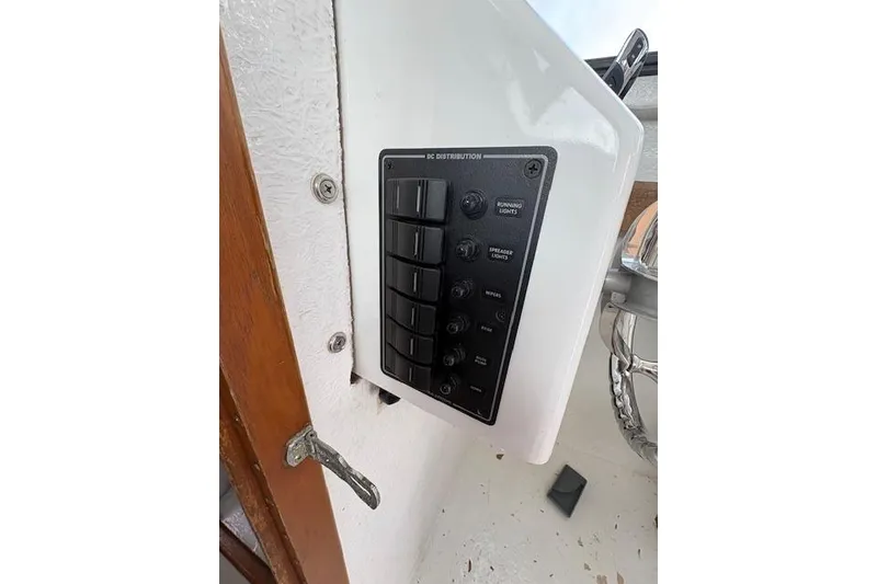 Slide: The Image of Control panel of a 1989 C-Hawk 29 Sport Cabin boat, featuring switches and labels. - 8