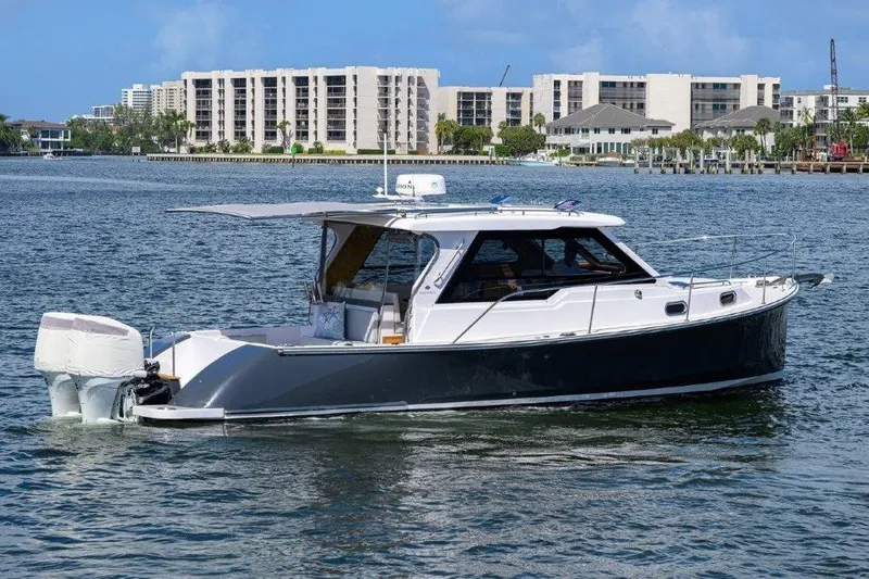 Slide: The Image of 2022 True North 34 boat on water with cityscape background. - 10