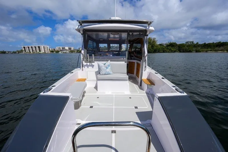 Slide: The Image of 2022 True North 34 boat on water, featuring spacious deck and modern design. - 16