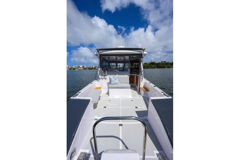 Slide: The Image of 2022 True North 34 boat on water, featuring spacious deck and clear blue sky. - 17