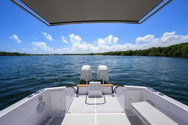 Slide: The Image of True North 34 boat on water, 2022 model, with canopy and scenic view. - 21