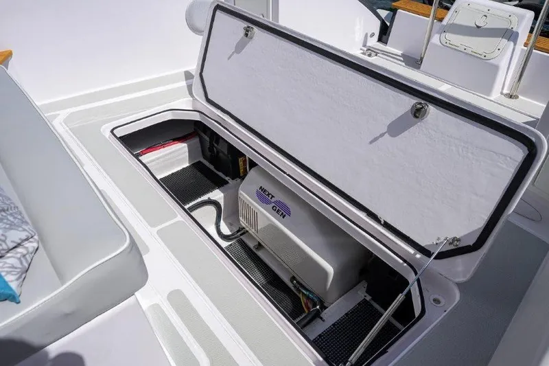 Slide: The Image of Open storage compartment on 2022 True North 34 boat, revealing NextGen generator. - 28