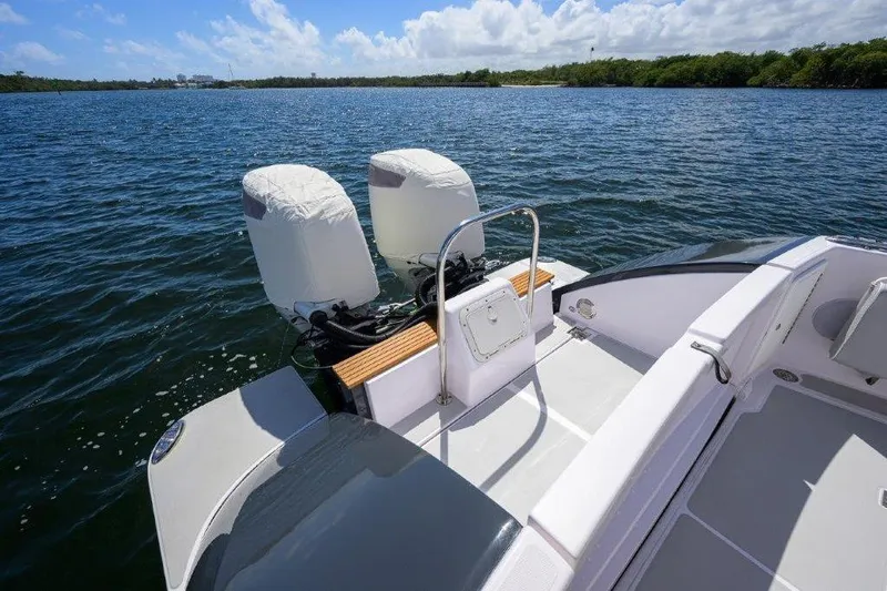 Slide: The Image of 2022 True North 34 boat with dual engines on a sunny lake. - 36